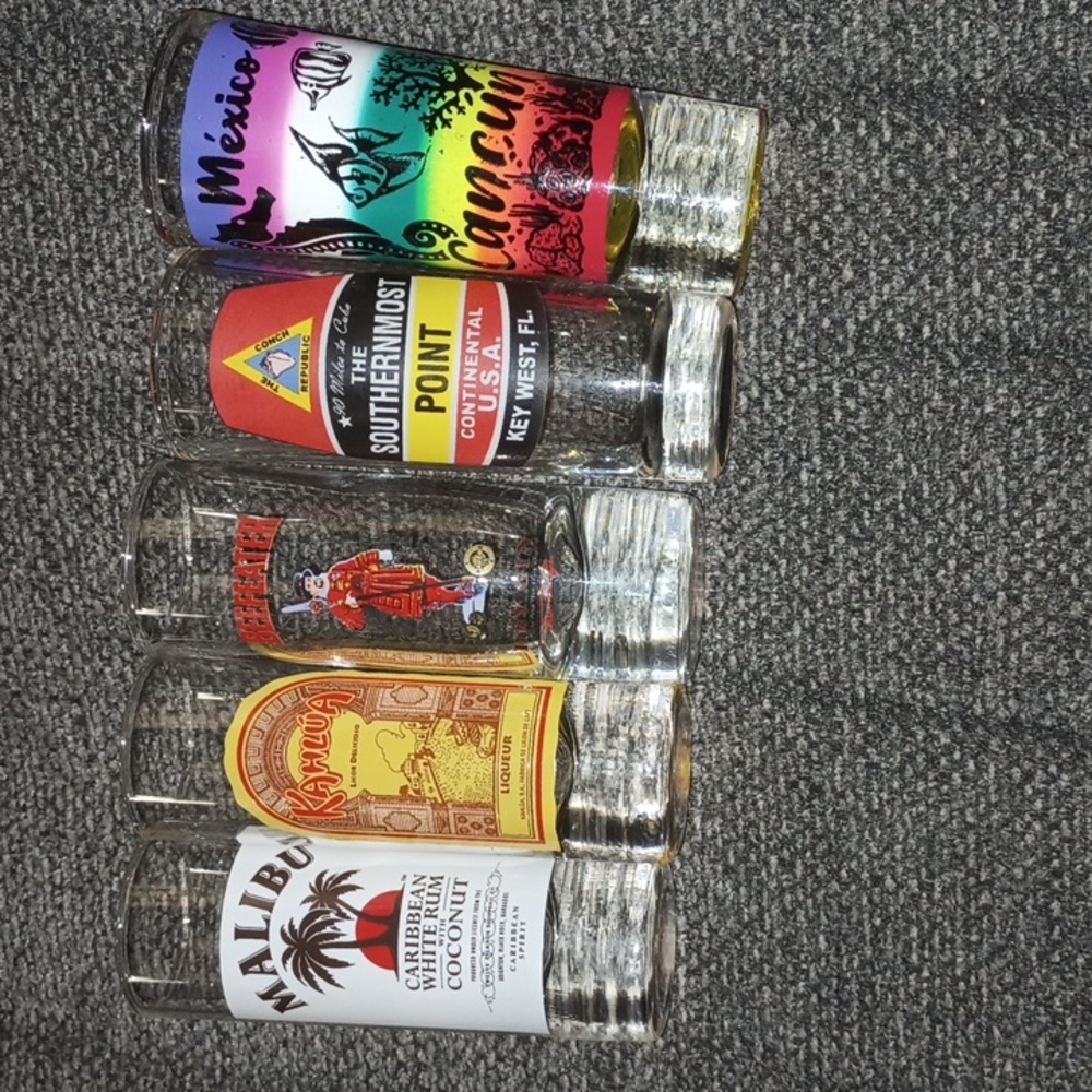 Five various shot glasses see pics . Malibu beefeaters, Kahlua ,Cancun